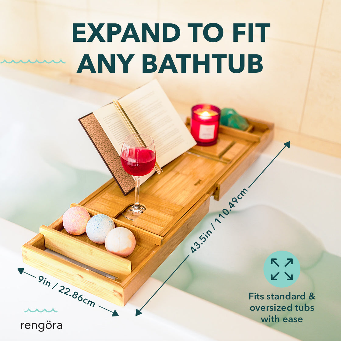 The bath caddy extended to fit a large bathtub, holding multiple items including bath bombs, a book, and a wine glass.