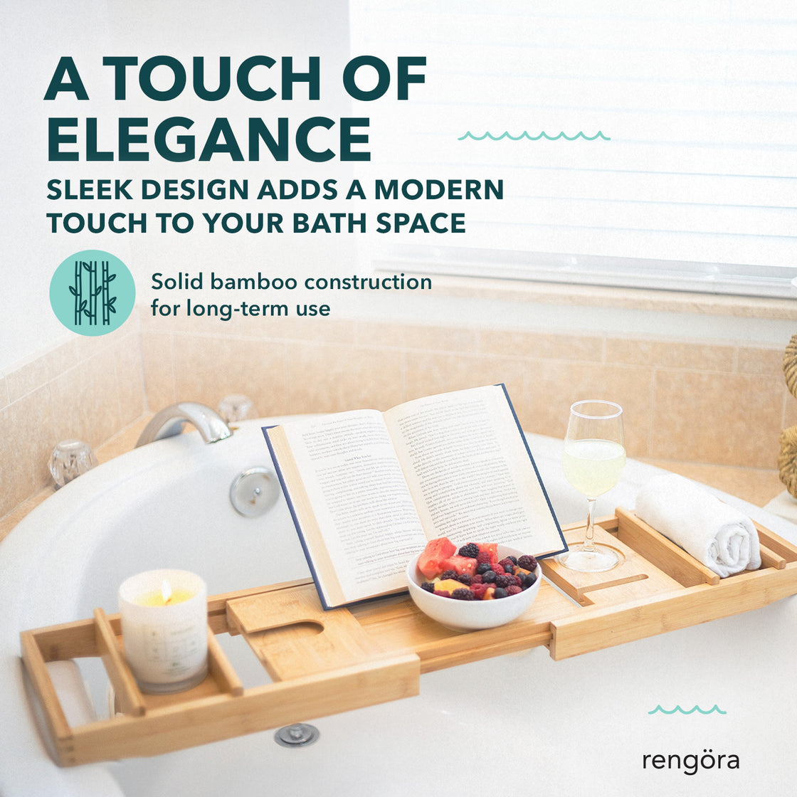 A bamboo bath caddy on a bathtub with a book, wine glass, and fruit bowl, highlighting its sleek design and ability to elevate bath space aesthetics.