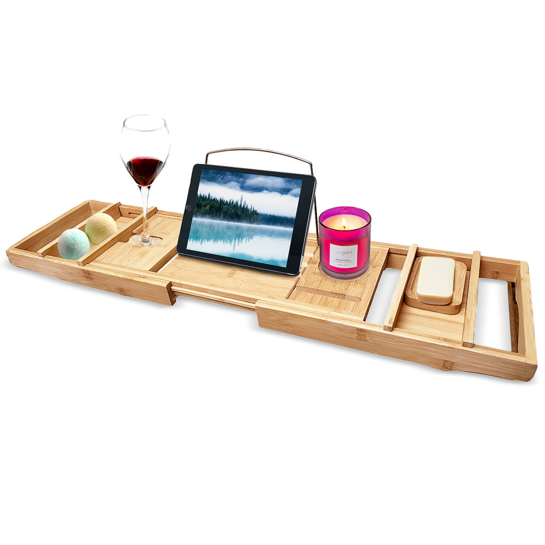 A bamboo bath caddy with a glass of red wine, a candle, a bar of soap, and a tablet, showcasing its multifunctional design and luxury feel