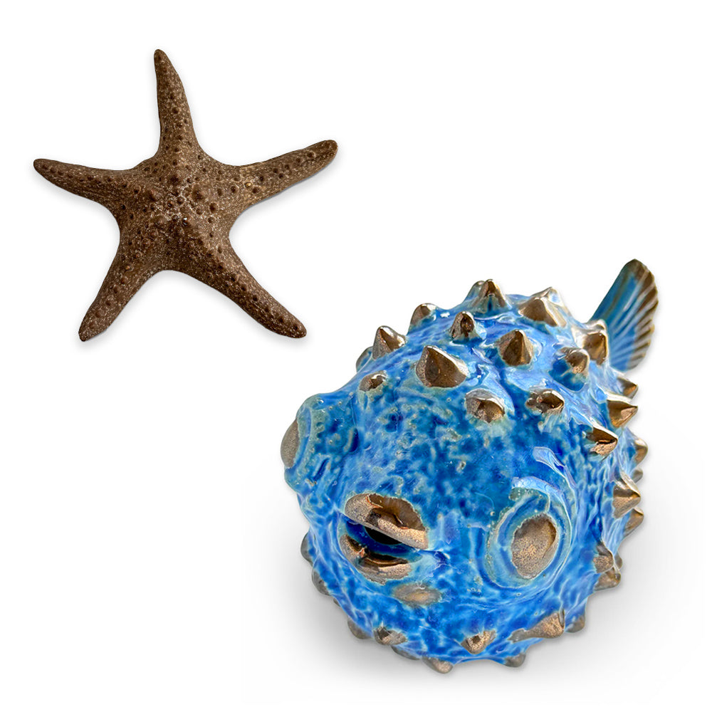 A decorative ceramic starfish and pufferfish set, perfect for coastal-themed decor.