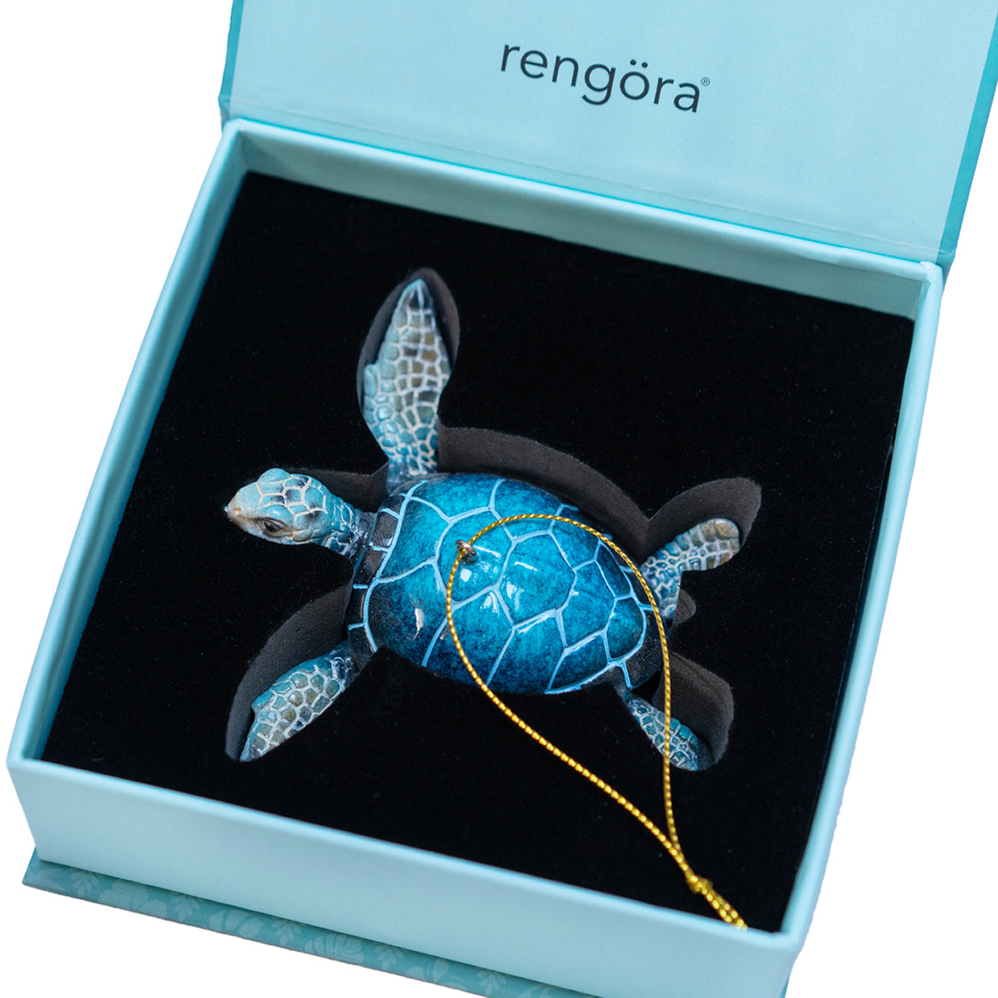 Interior view of blue sea turtle box with black foam that holds the sea turtle Christmas ornament securely