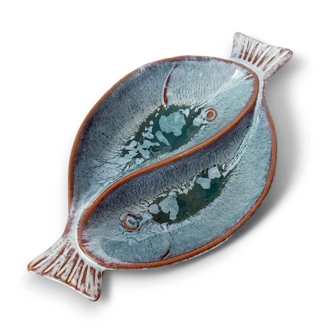 Handcrafted ceramic dual fish-shaped serving bowl with a glossy blue-grey glaze and elegant texture on a white background.