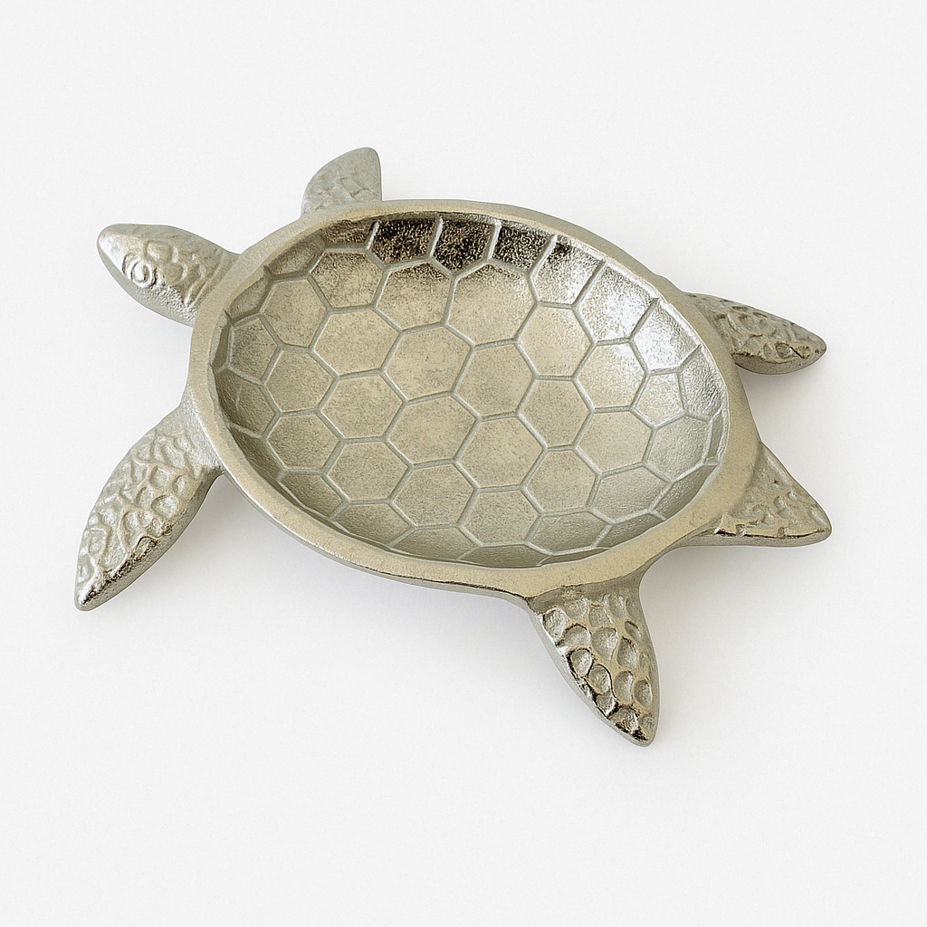 Studio image of an empty silver turtle jewelry tray on a white background showing its textured shell bowl and flippers.