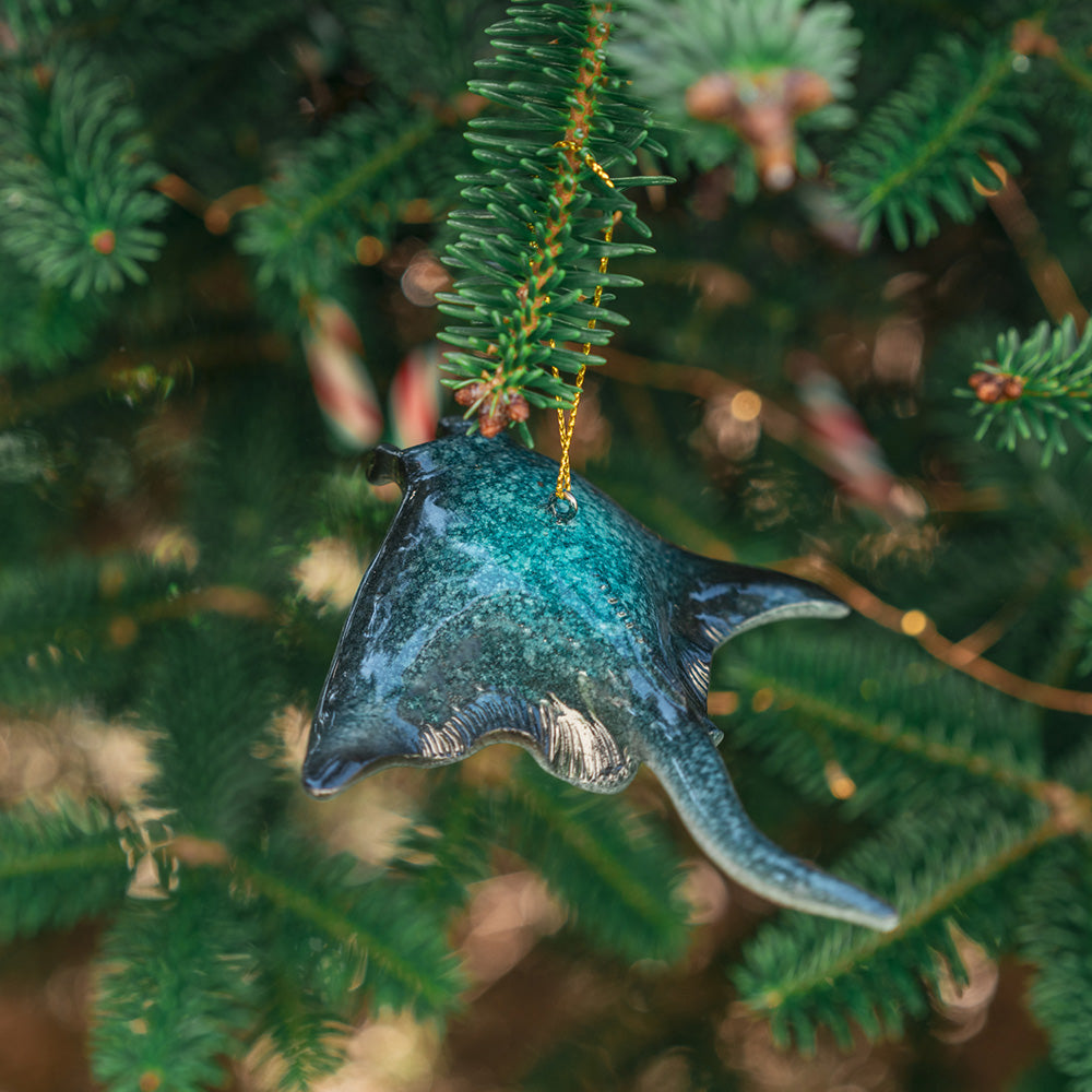 A detailed close-up of a hanging rengora manta ray ornament adorning a Christmas tree