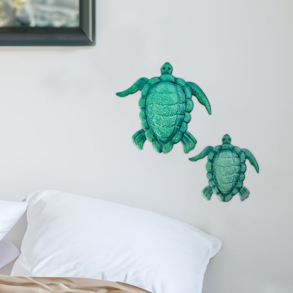 Displaying elegance within the room the enameled metal sea turtles by rengöra featuring both a mother and child are gracefully mounted on the wall