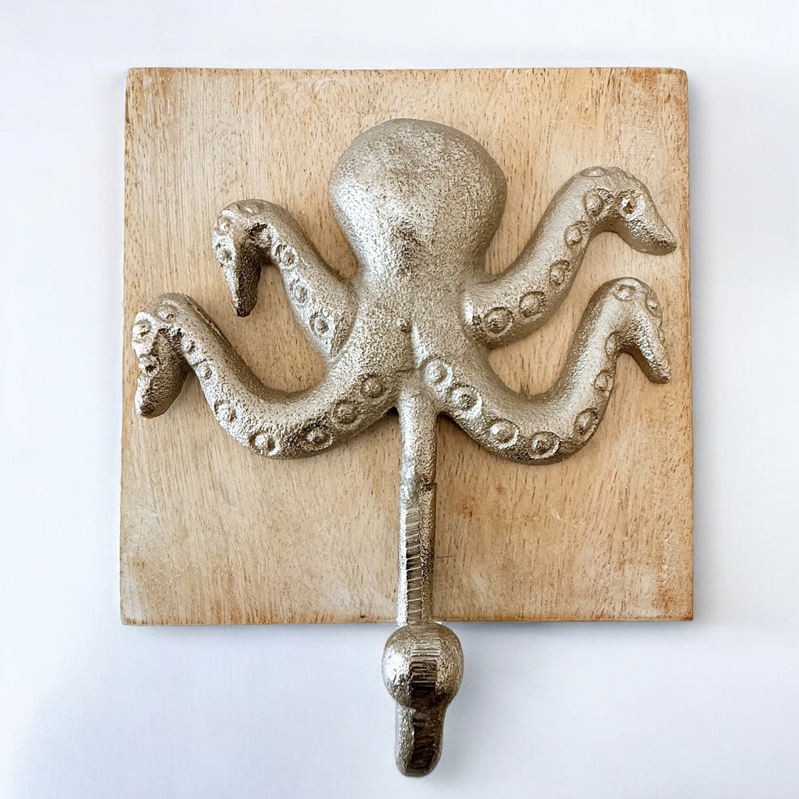 Close-up of a silver metal octopus wall hook mounted on a natural wood square base, photographed against a white background.