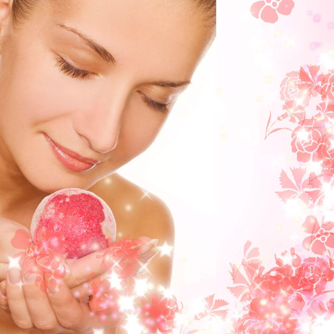 woman holding a pink and white colored bath bomb appearing to enjoy the fragrance - with pink flower and star pattern in the background