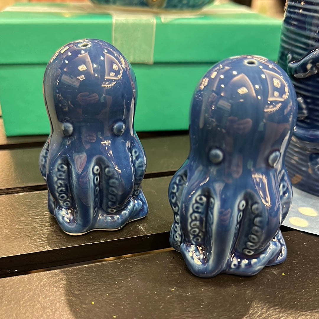 Royal blue (almost navy) set of cute ceramic octopus salt and pepper shakers sitting on a table