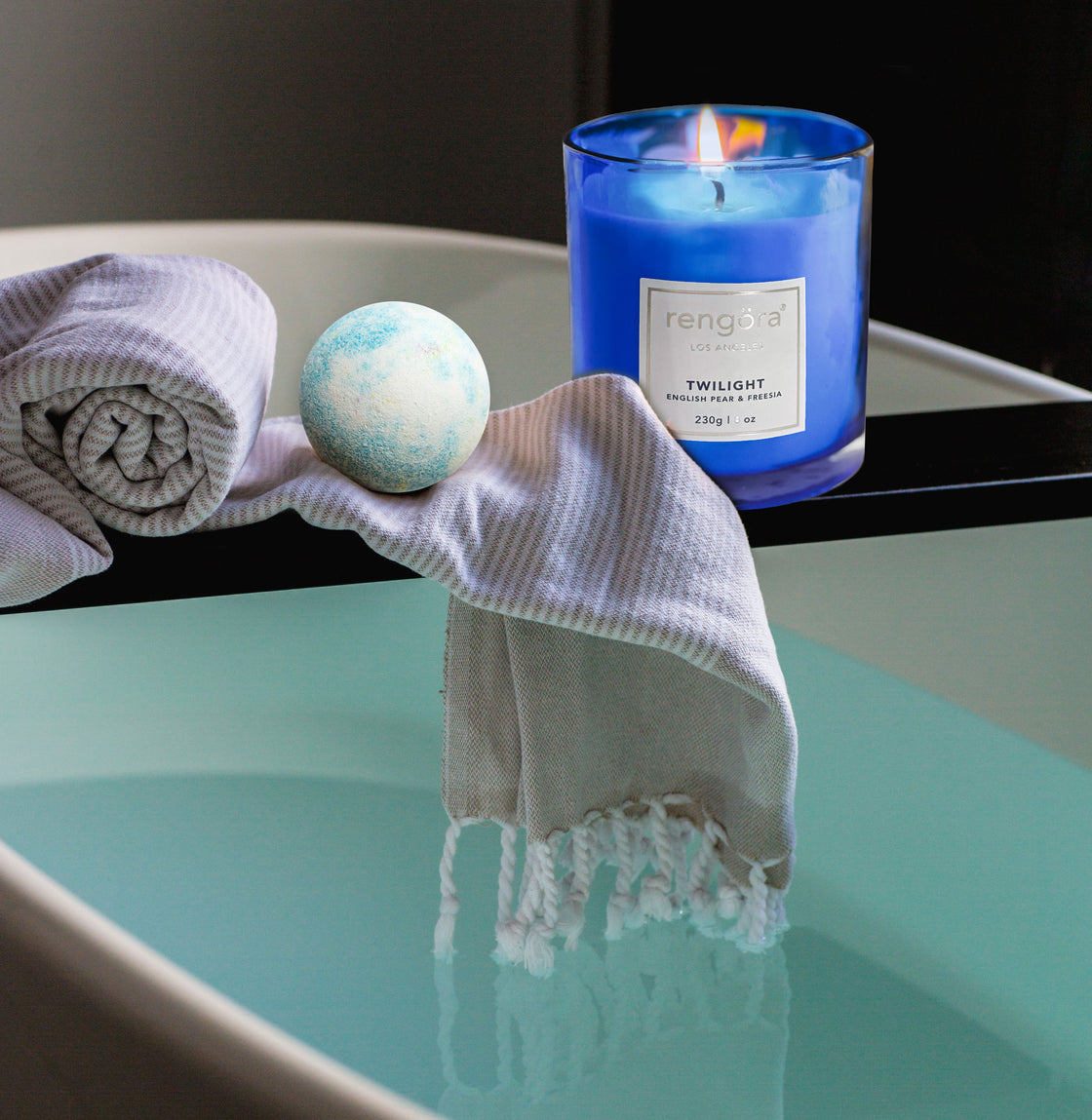 rengöra's Twilight-scented home candle presented in an exquisite cobalt blue glass featuring English pear and freesia is partnered with a Rengora bath bomb  all set for a relaxing bath time experience!"