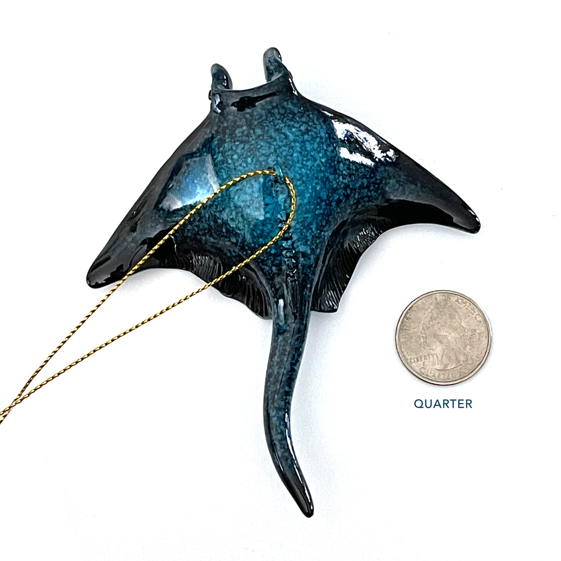 Comparing the size of the Rengora Christmas ornament to that of a coin