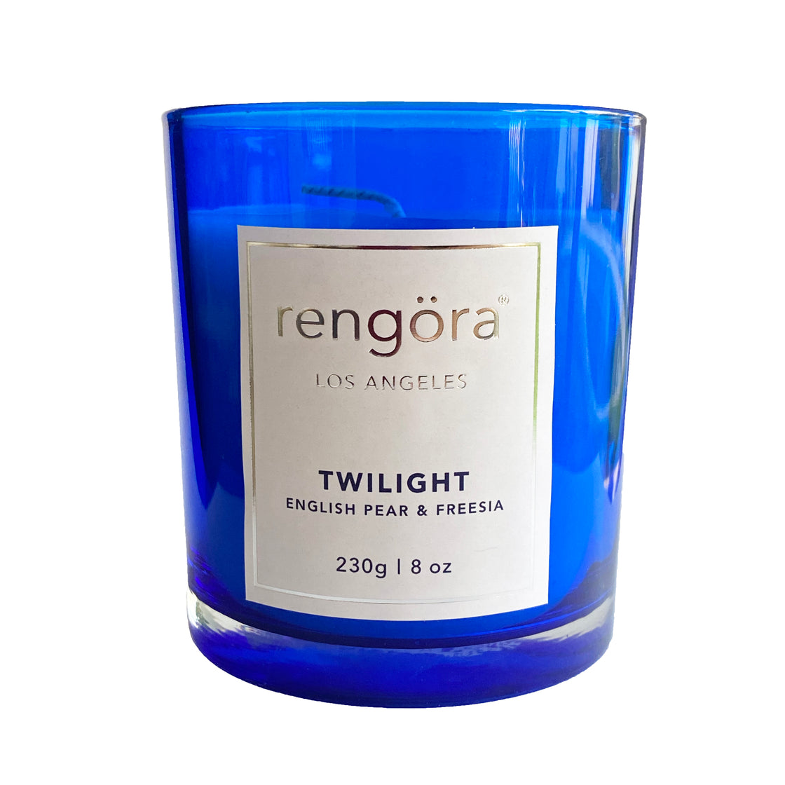 Against a pristine white background, the rengöra twilight scented home candle is elegantly showcased within its cobalt blue glass vessel, creating a striking visual contrast