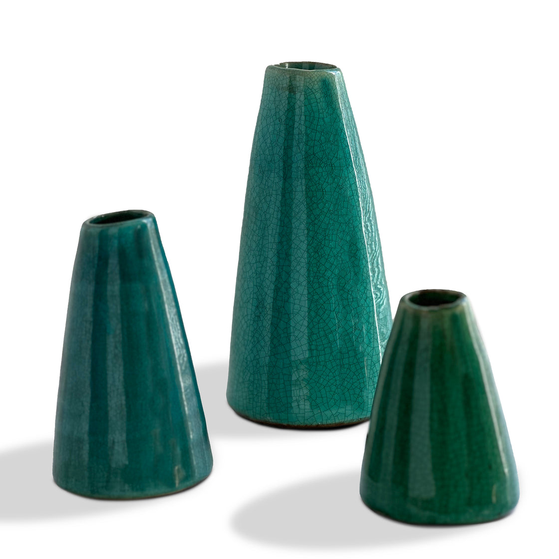 An exquisite collection of three distinct artisanal vases featuring gentle shimmering aqua tones and an elegant crackle finish presented against a clean white backdrop