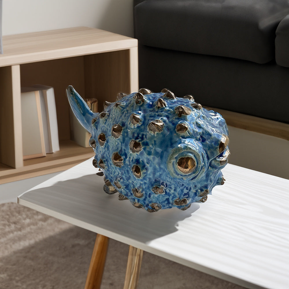 A ceramic pufferfish in a rich royal blue and gold color scheme, making it an excellent choice for beach-inspired ocean decor by rengöra