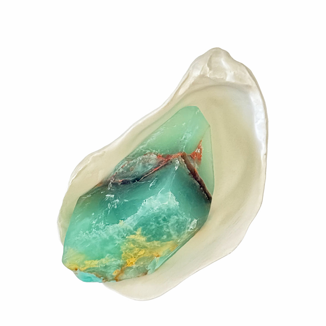Turquoise stone-like SoapRock© on an oyster shell soap dish / trinket dish on a white background