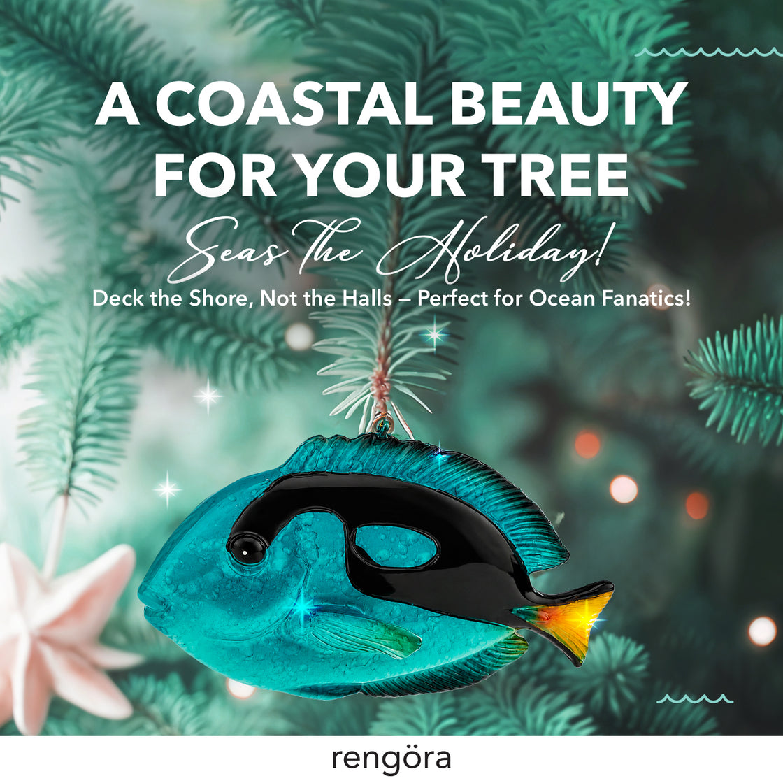 Blue tang Christmas ornament displayed with coastal holiday greenery and festive ocean-inspired décor.