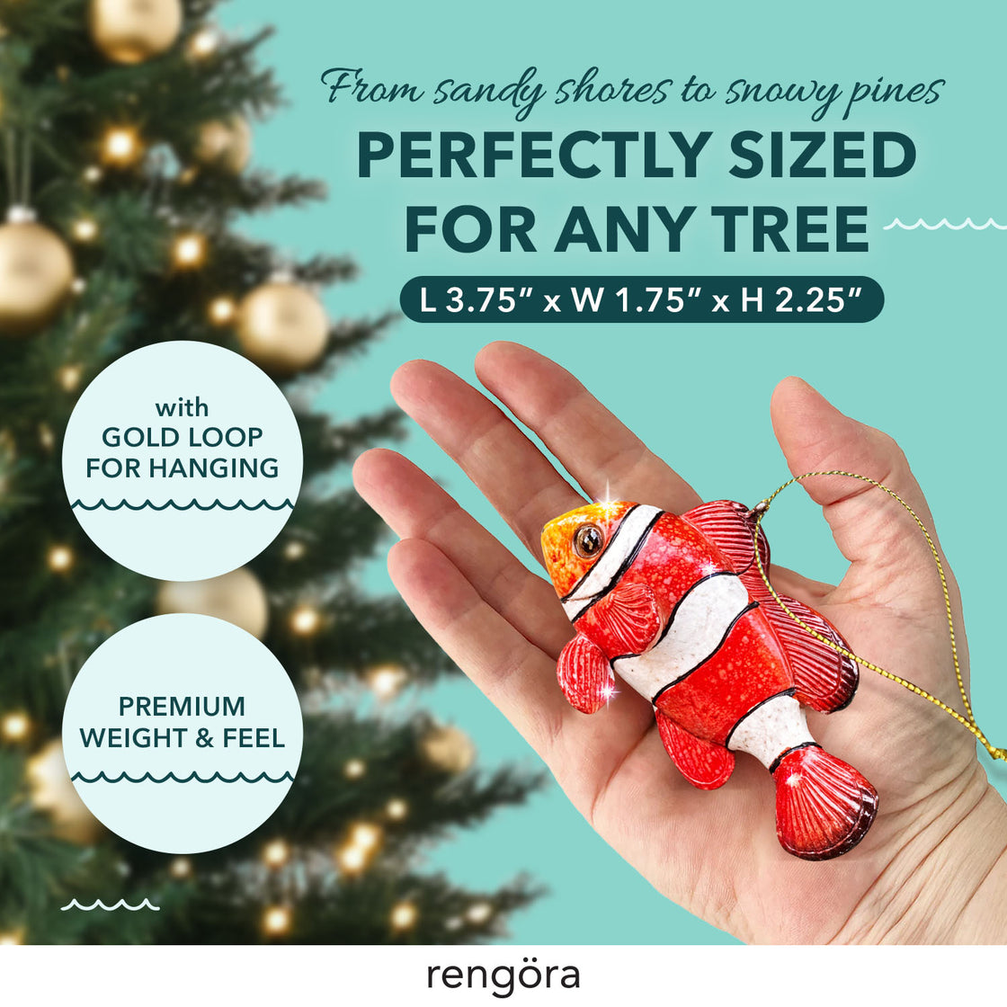 Clownfish ornament resting in someone’s hand, showing off its vibrant coloration and scale-like texture. A holiday tree with twinkling lights is seen in the background.