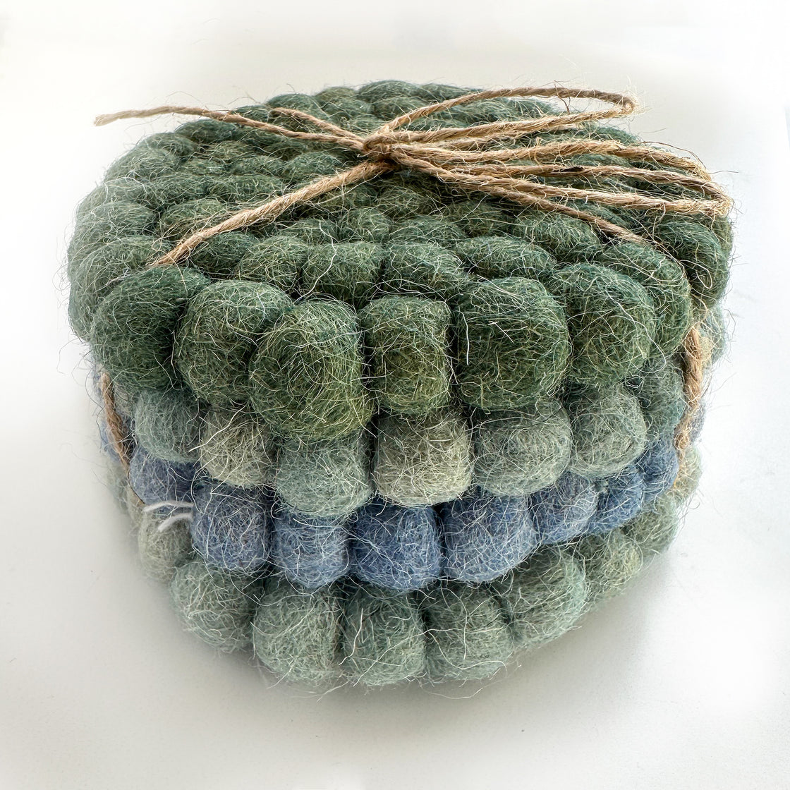 a set of four rengora coasters bundled together using a twine string by rengöra