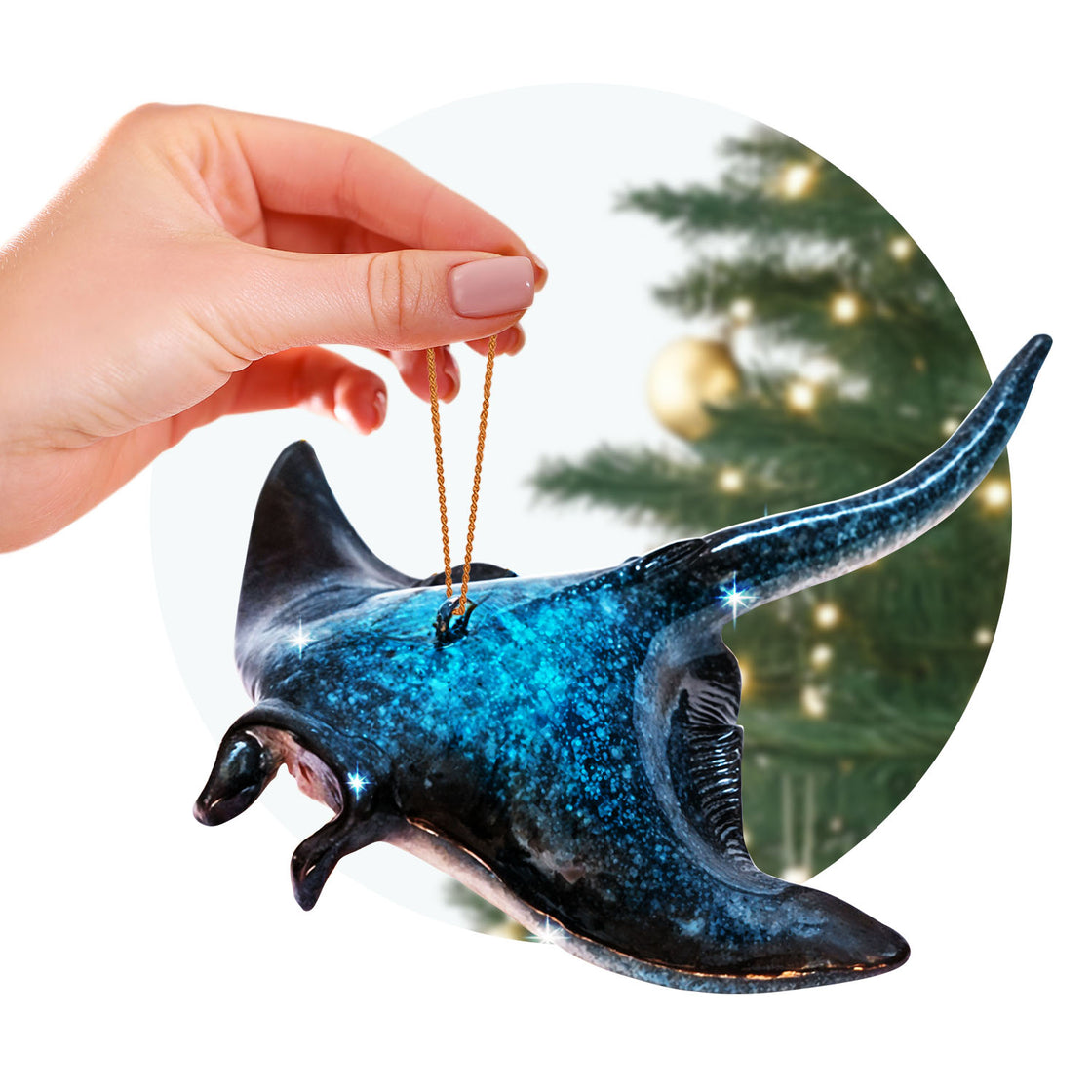 rengöra manta ray ornament held by a hand with a golden string, against the blurred backdrop of a decorated Christmas tree