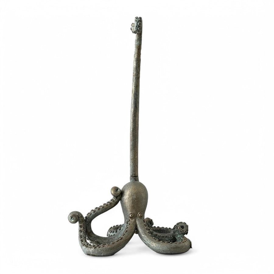 Isolated image of the octopus-shaped paper towel holder on a white background, showing its sculptural tentacle design and patina finish.