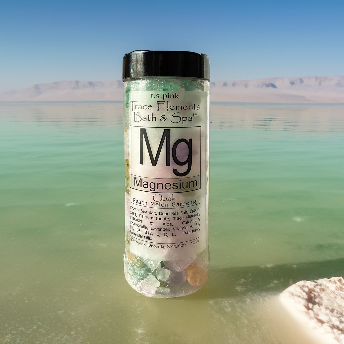 A jar filled with Rengöra magnesium-infused bath salts sits on a salt lake surface with a mountain background. The label highlights "Mg Magnesium.