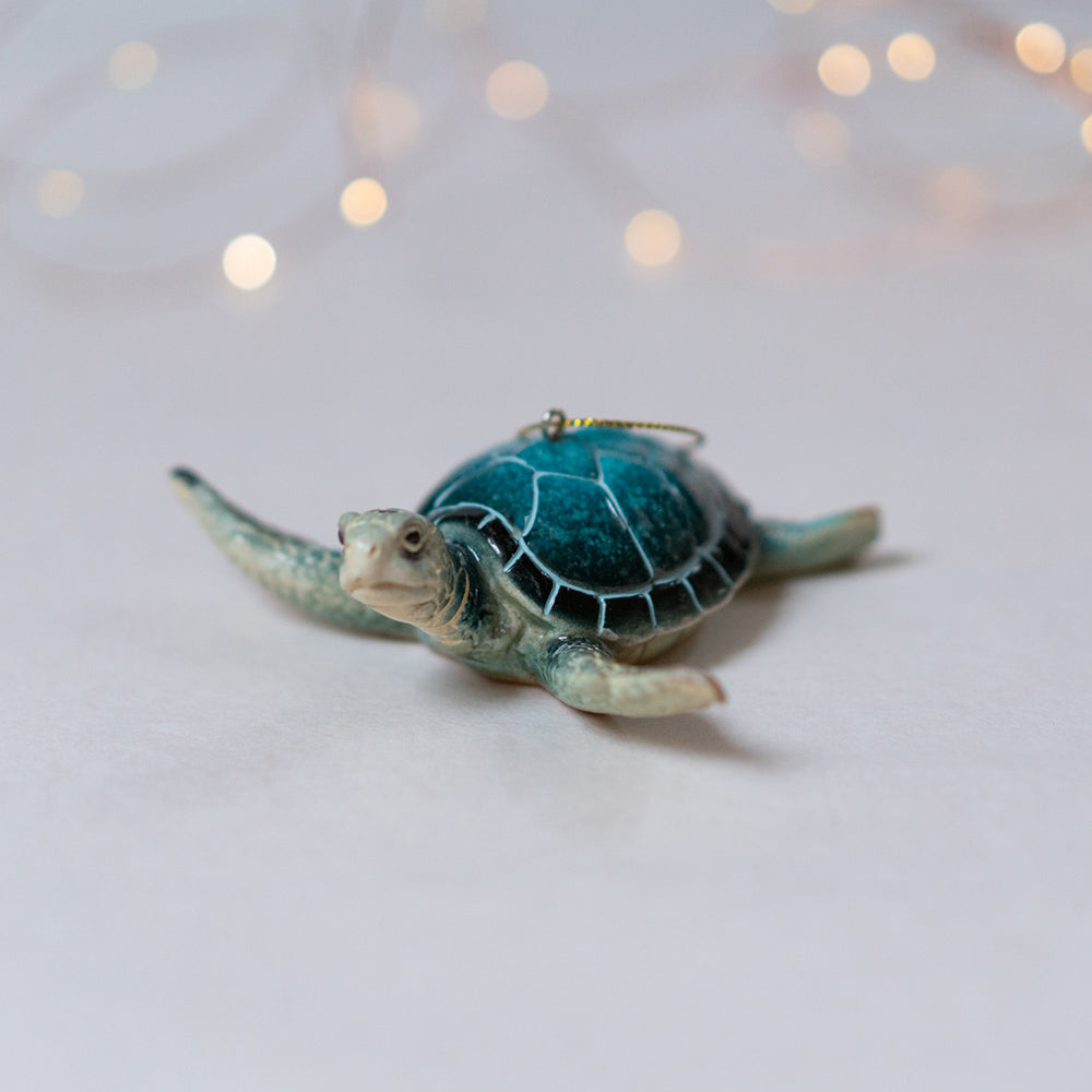 rengora Blue Sea Turtle Ornament with white Christmas lights blurred in the background