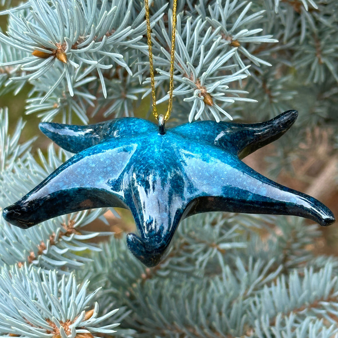 rengora Blue starfish ornament with intricate details, hanging on a Christmas tree