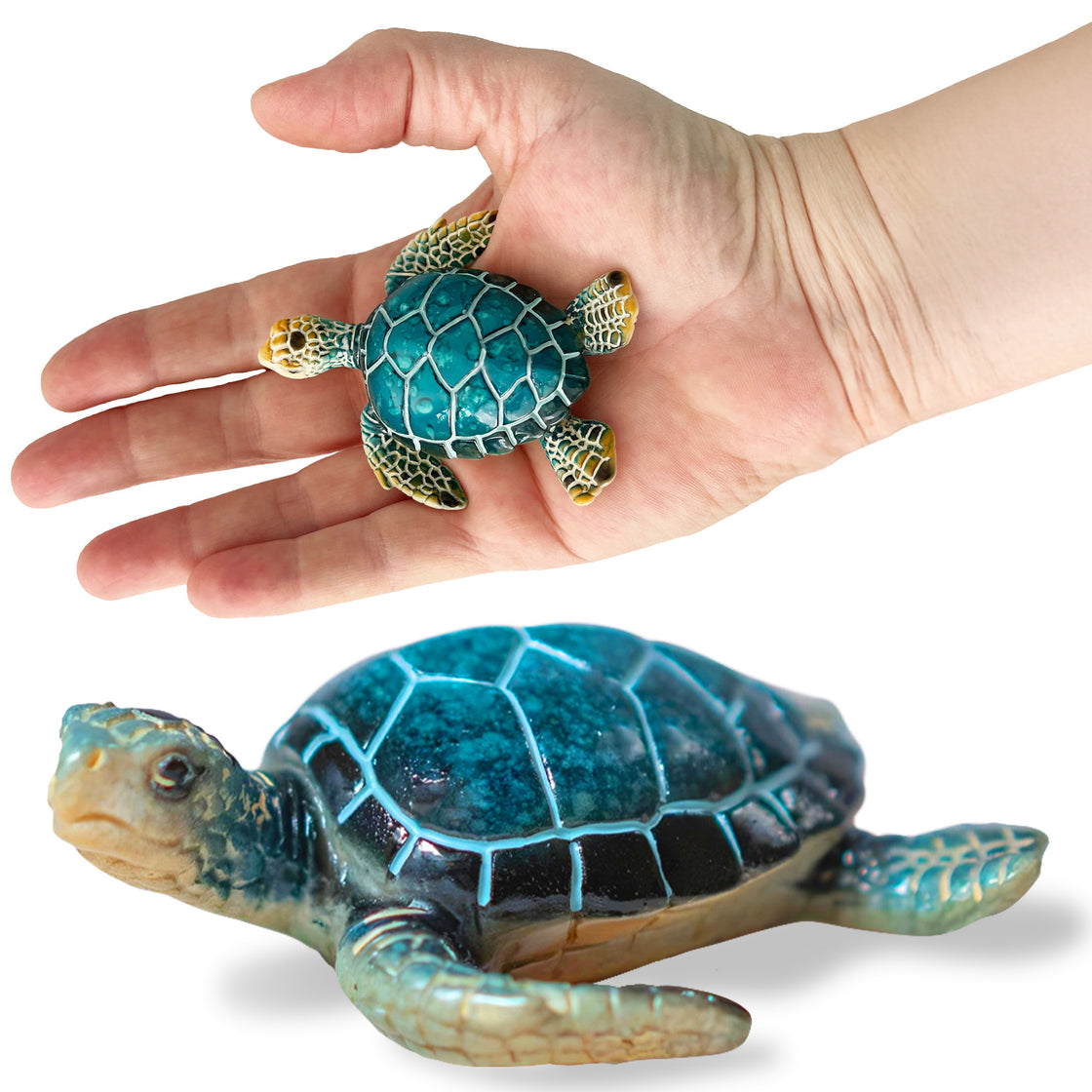 Close-up of a hand holding a small, intricately detailed blue sea turtle magnet with another view of the magnet resting on a white background below.
