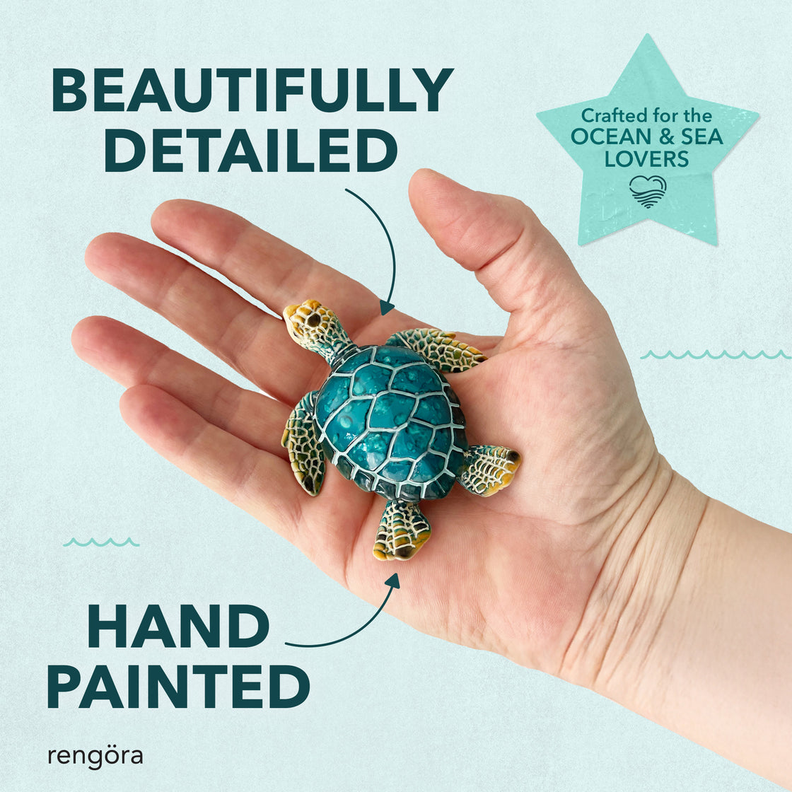 Hand holding a small hand-painted blue sea turtle magnet, with text calling out its detailed craftsmanship, labeled “Beautifully Detailed” and “Hand Painted.