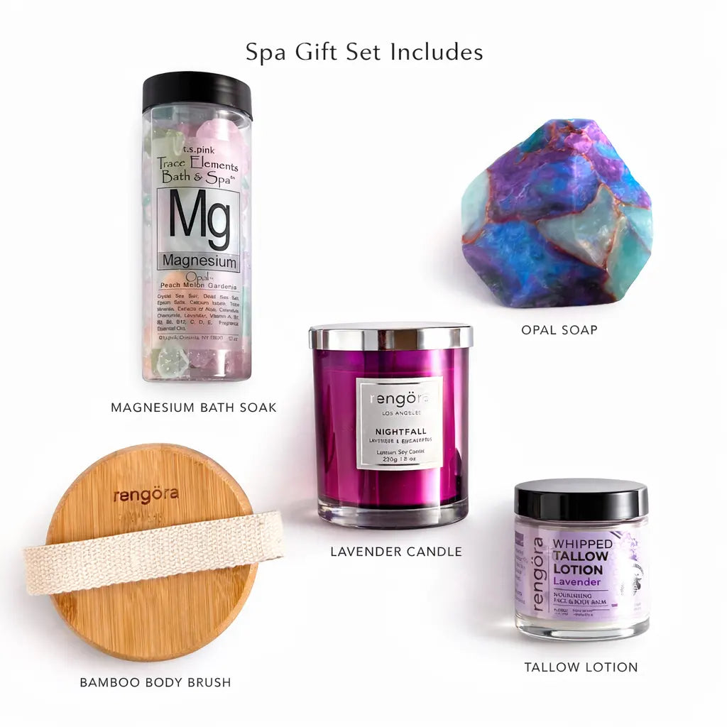 Spa gift set with magnesium bath soak, lavender candle, opal soap, bamboo body brush, and tallow lotion on a white background.