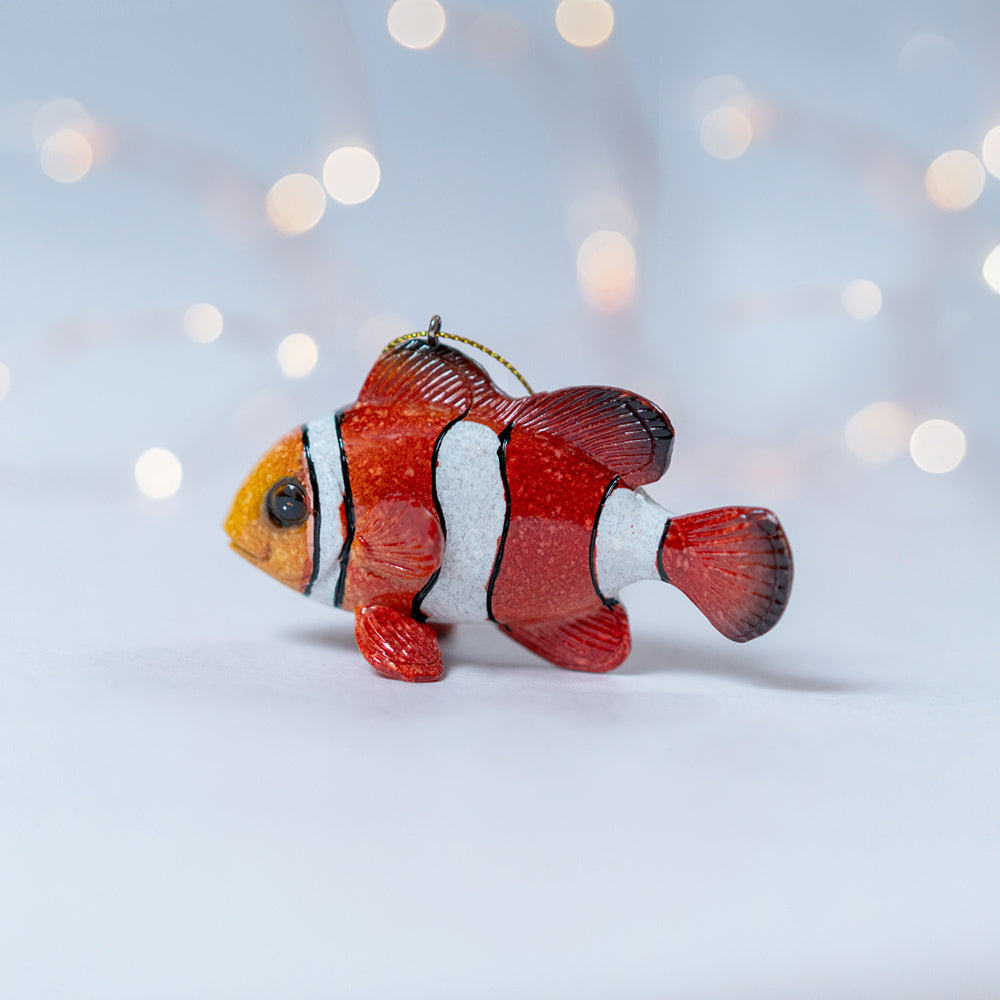 Side view of rengora tropical fish ornament stands out against a background of a blurred dreamy atmosphere illuminated by the soft glow of Christmas lights