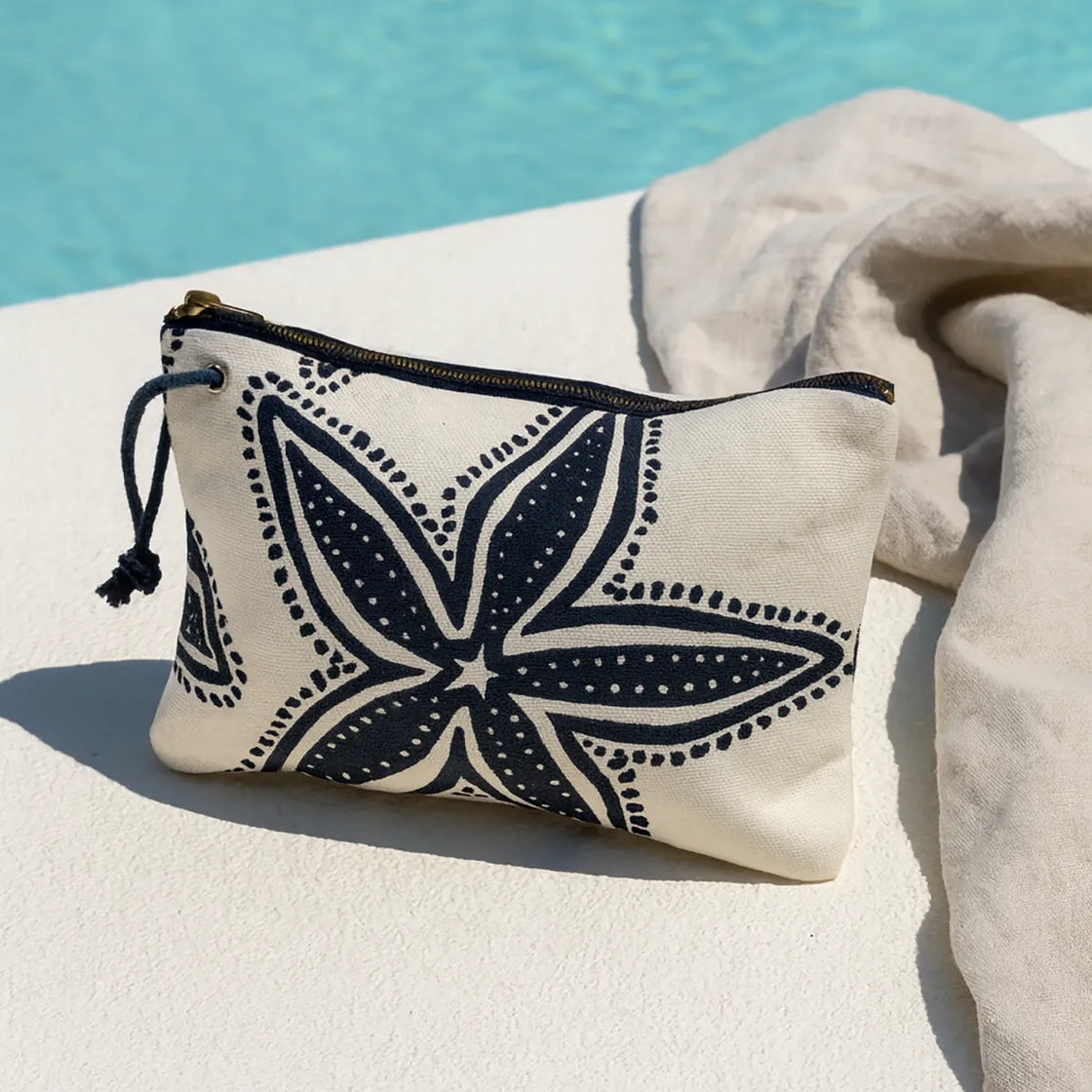 Rengöra beach-style cotton canvas cosmetic bag with navy starfish print near swimming pool