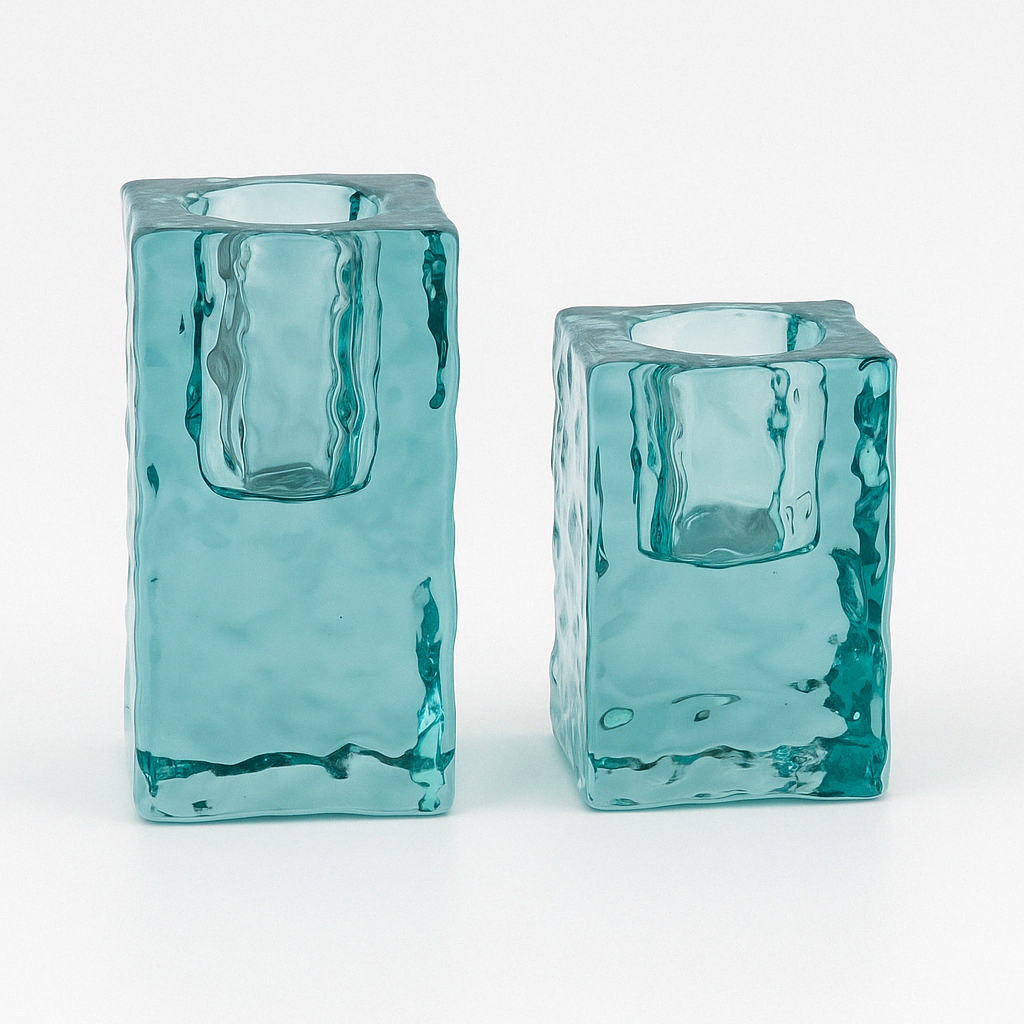 Studio photo of turquoise glass candle holders in two heights on a white background, showing their textured ocean-inspired design.