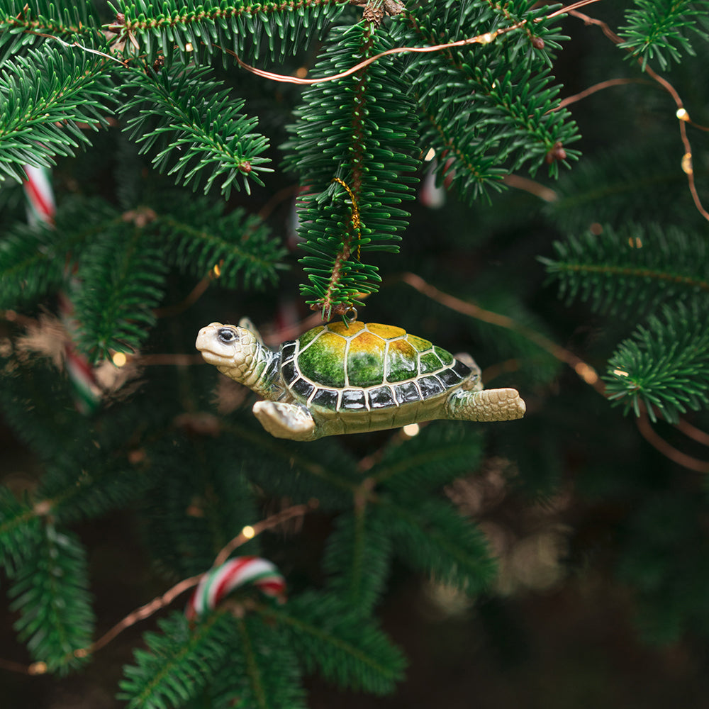 adorable hand-painted green sea turtle ceramic ornament hanging on Christmas tree