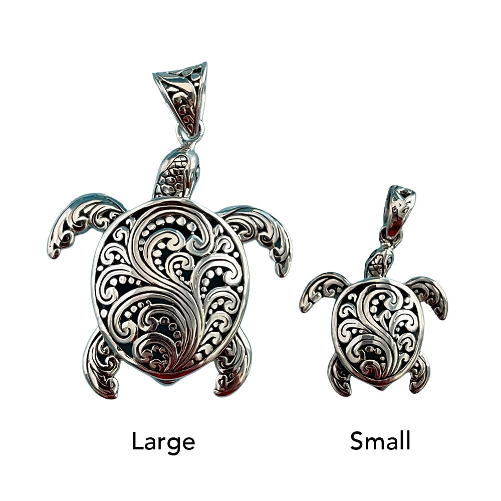 Two silver turtle pendants, one large and one small, on a white background.