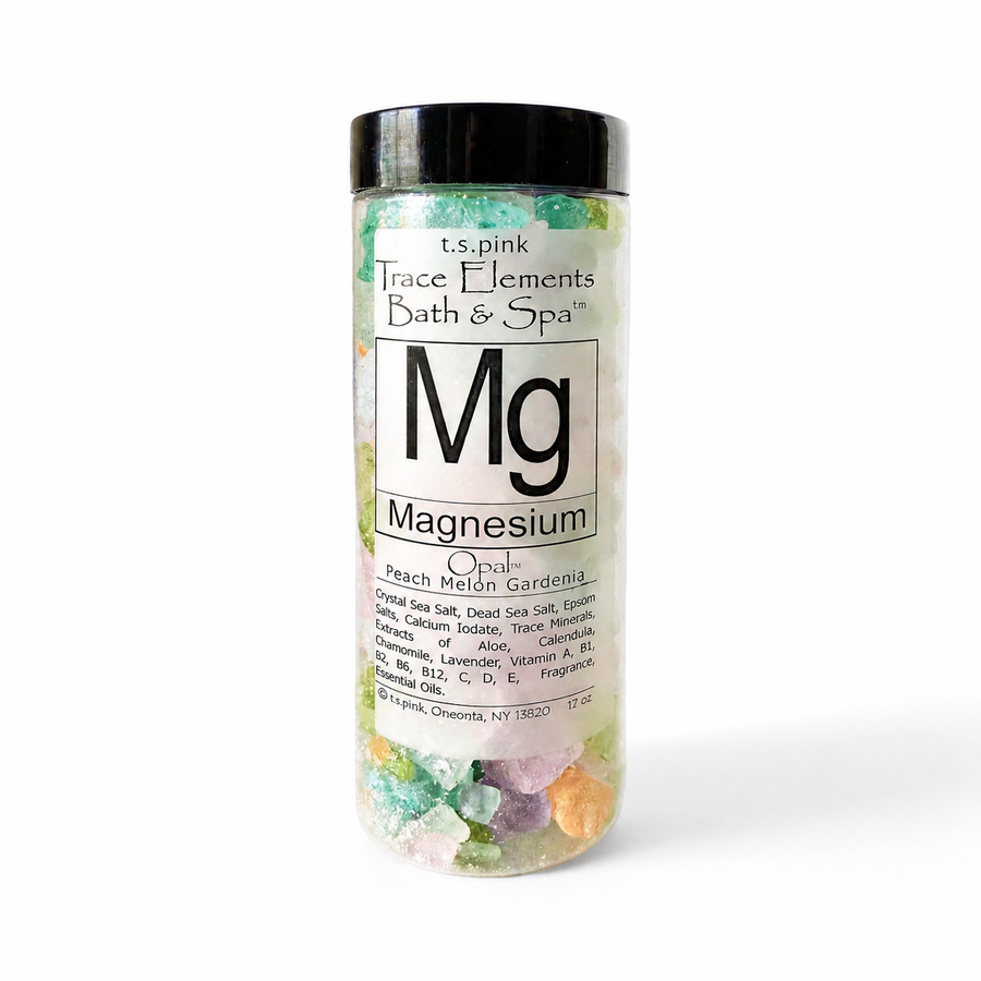 Bottle of magnesium salts with colorful crystals on a white background