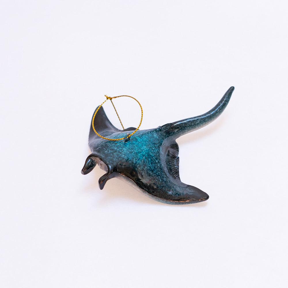 The rengora manta ray Christmas ornament displaying its stunning aquamarine navy blue hand-painted color set against a clean white background showcasing its beauty