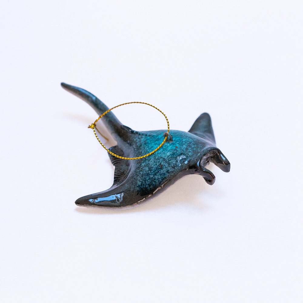 Displaying the exquisite hand-painted aquamarine navy blue color of the rengora manta ray Christmas ornament set against a simple white background to enhance its beauty