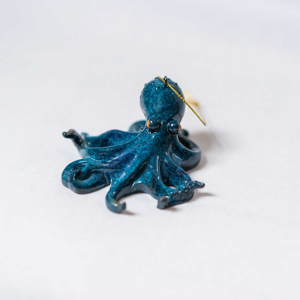 An intricate view of the Rengora octopus showcasing its lustrous hand-painted turquoise blue color against a simple white backdrop