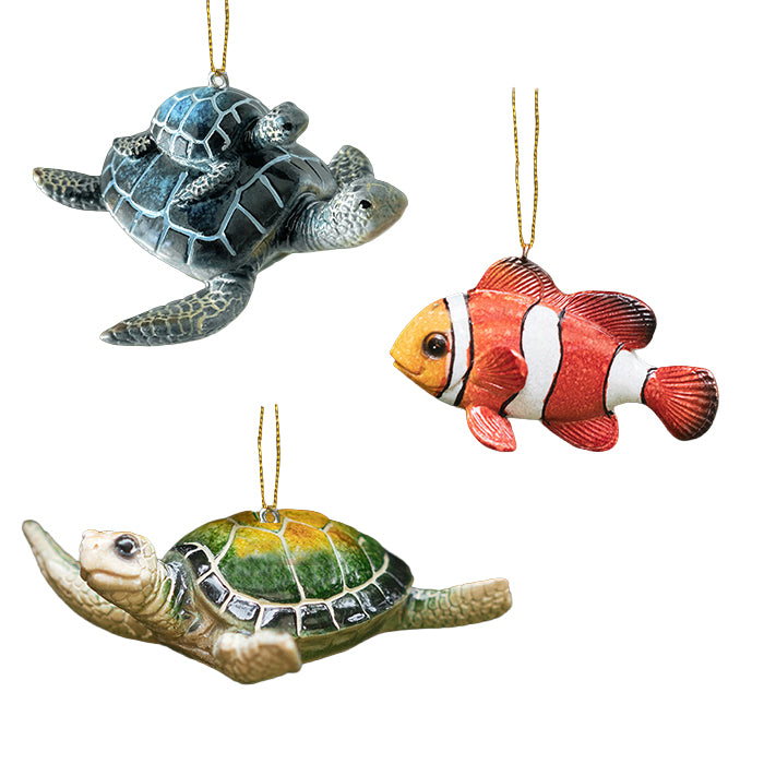 Two turtle ornaments and one clownfish ornament on a white background