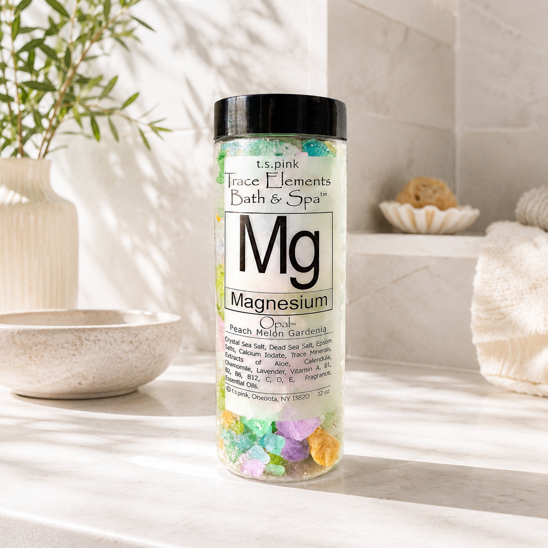 Bottle of magnesium bath salts with colorful crystals on a bathroom counter.