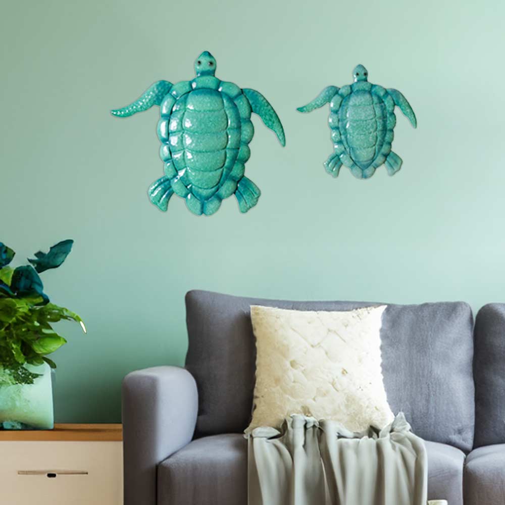Displaying elegance within the living room the enameled metal sea turtles by rengöra featuring both a mother and child are gracefully mounted on the wall