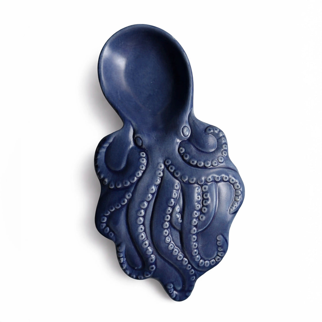 Blue ceramic spoon rest shaped like an octopus on a white background