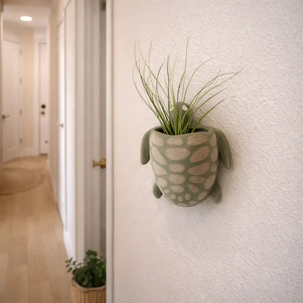 Decorative plant pot shaped like a turtle on a wall in a hallway.