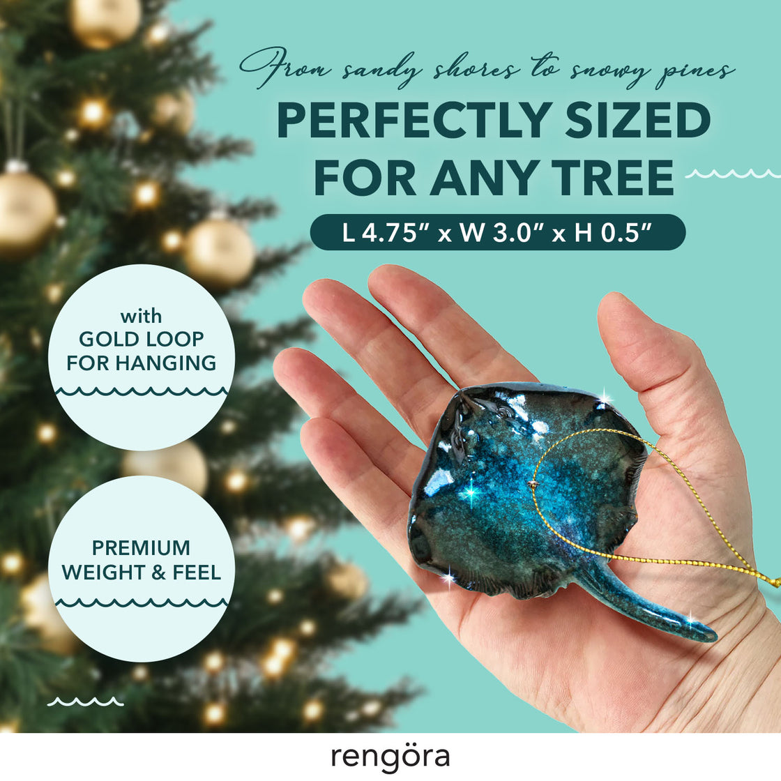 A person’s hand displaying a teal-colored stingray ornament, highlighting its subtle sparkles and curved shape. A holiday tree with golden ornaments is blurred behind, emphasizing the ornament’s size and design.