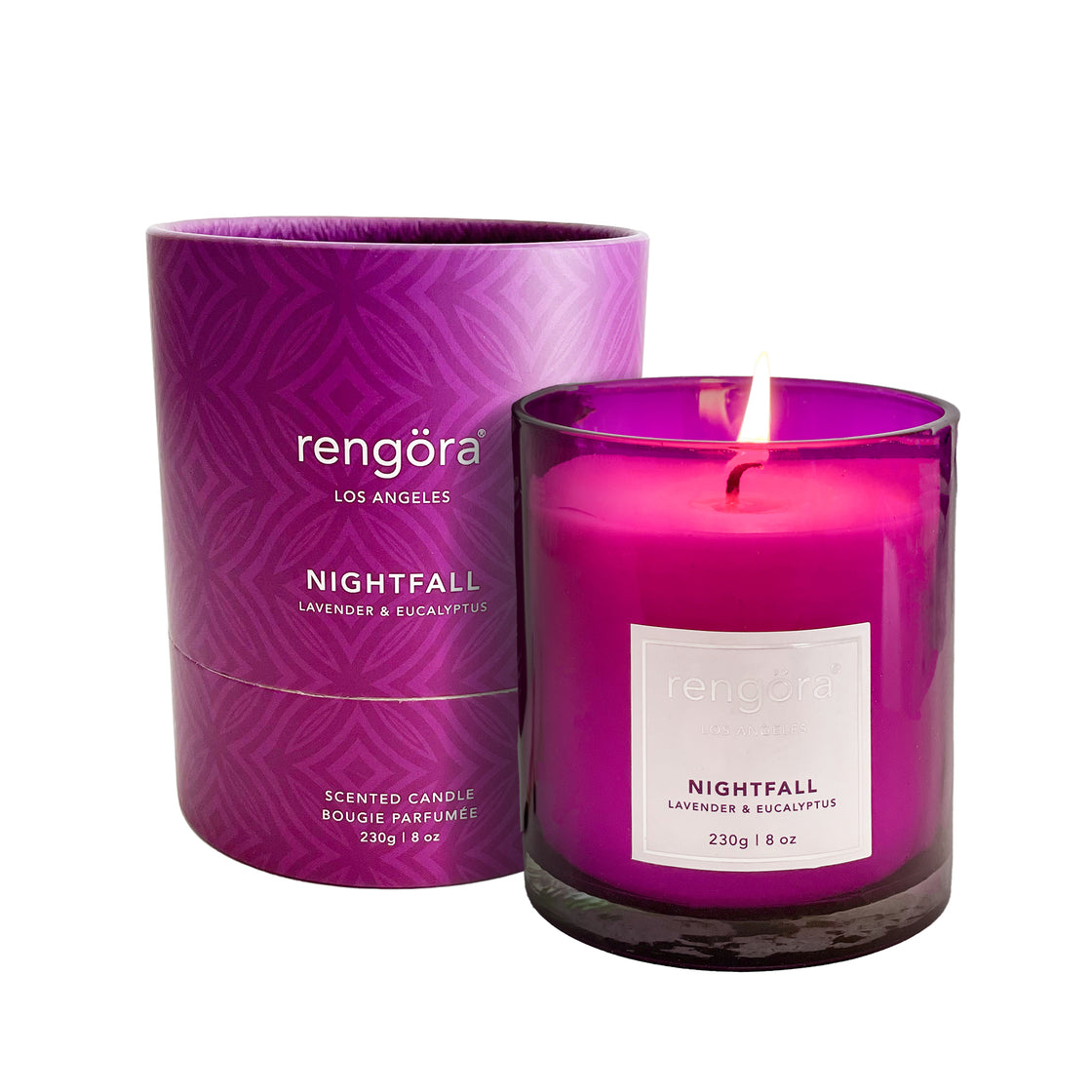 A soy wax candle infused with the soothing scents of lavender and eucalyptus, adorned with real eucalyptus leaves and packaged in a beautiful purple box, showcased against a simple white background