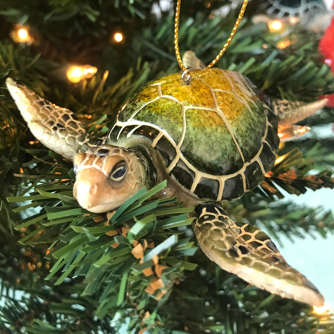 Green sea turtle ceramic ornament hanging on Christmas tree