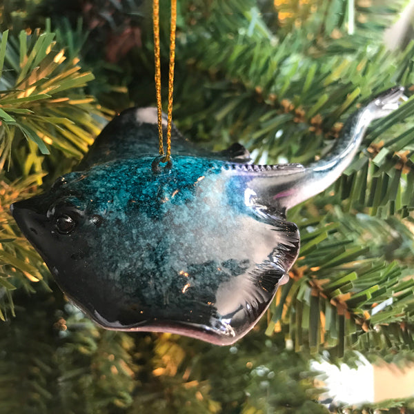 Blue Stingray Christmas ornament hanging on green tree