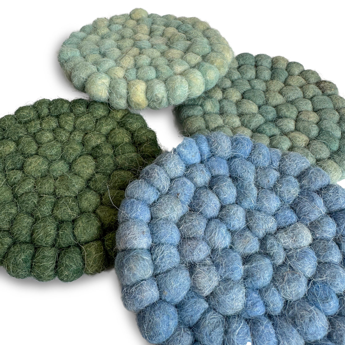 A set of four coastal wool coasters featuring soothing seaside colors by rengöra