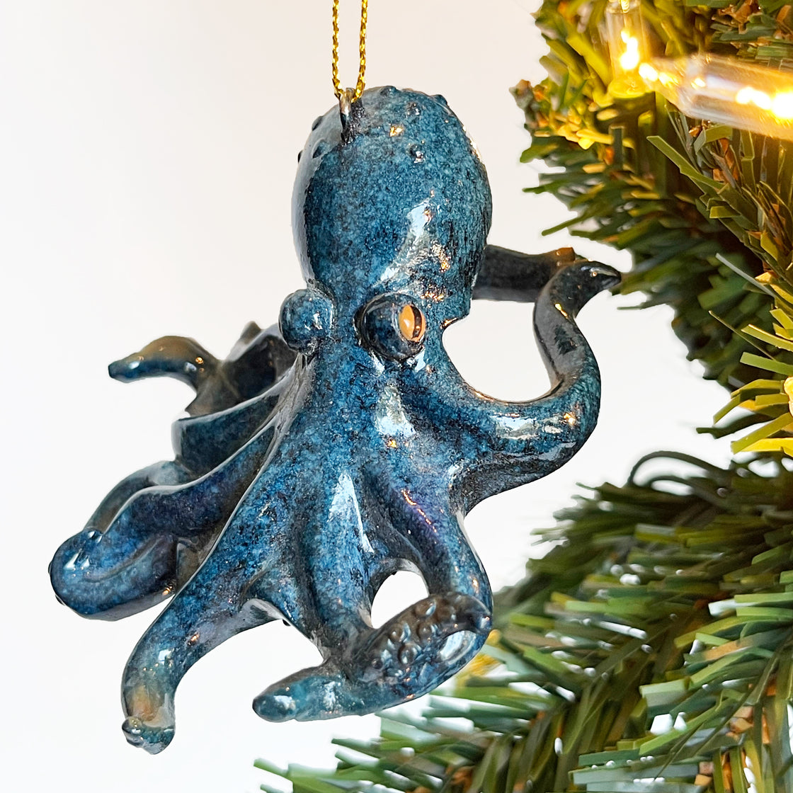 On a Christmas tree adorned with holiday lights the intricate bluish octopus design by rengora mirrors the lifelike appearance of an actual octopus