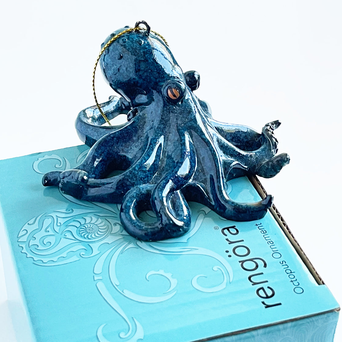 The Rengora octopus ornament is elegantly perched on its own packaging